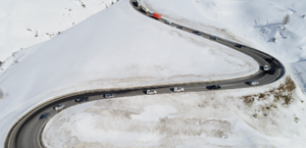 aerial view of cars driving on a winding road